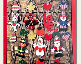 May include: A collection of plastic canvas patterns for creating various holiday and seasonal decorations. The patterns include a turkey, a ghost, a leprechaun, a pumpkin, a heart, a Santa Claus, a shamrock, a leaf, an apple, an Easter egg, a bunny, and a love sign.