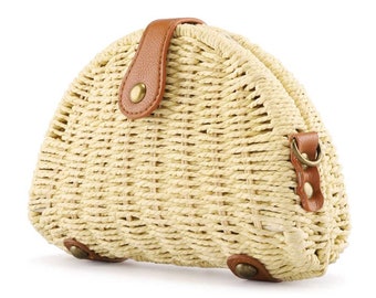 May include: A half-moon shaped straw bag with a brown leather strap and a metal buckle. The bag has a woven texture and is a light beige color.