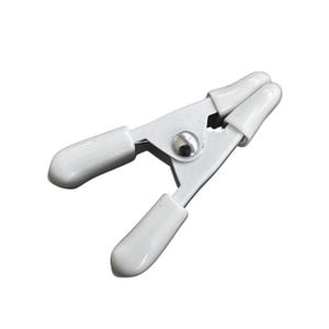 May include: A white spring clamp with rounded, rubber-coated jaws. The metal clamp has a silver rivet in the centre. The jaws are open, ready to grip an object. This clamp is used for various crafting and photography projects.