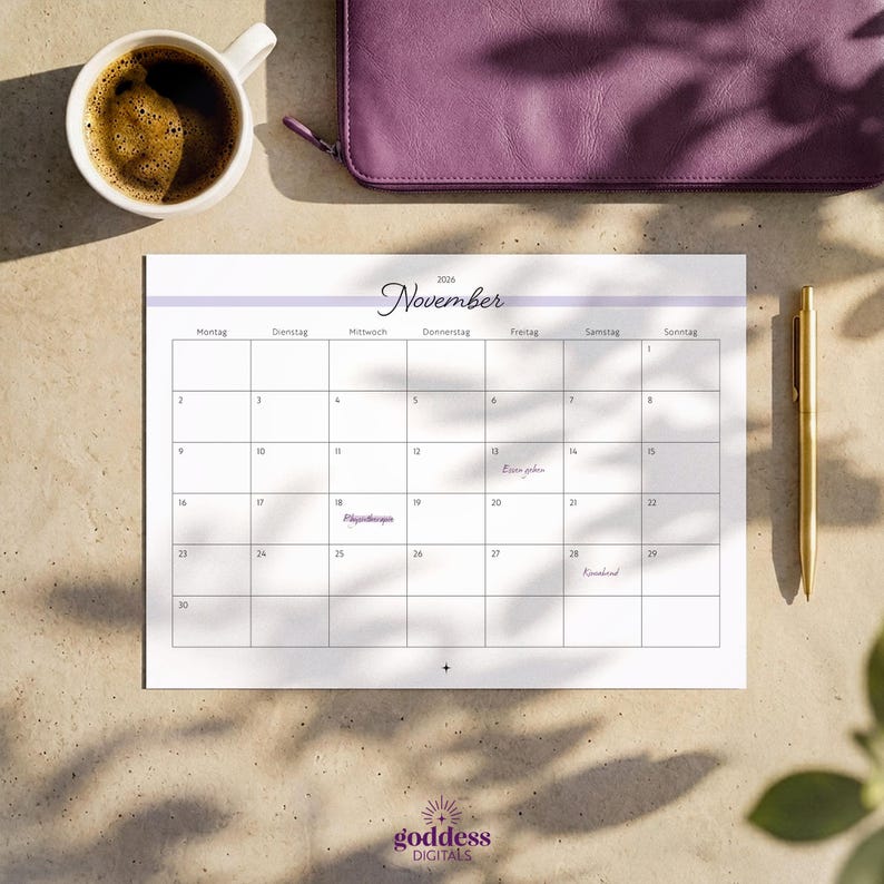 May include: A 2026 November calendar page with a white background, black grid lines, and a light purple header. The text includes the month name, days of the week in German, and dates. A gold pen is positioned to the right of the calendar sheet.