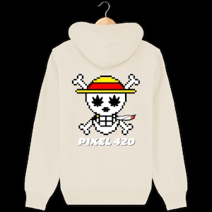 Peut inclure: Un sweat à capuche crème avec un crâne pixelisé portant un chapeau rouge et jaune et tenant un joint. Le crâne a des feuilles de marijuana vertes pour les yeux. Le texte "PIXEL 420" est imprimé sous le crâne.