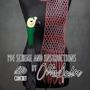 May include: A pink and red crochet scarf with fringe on a black dress form. The scarf is draped around the neck of the form. The text "PDF Scheme and Instructions by Olli Andre" is visible below the scarf. The text "Crochet" is visible below the text.