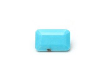May include: A light blue turquoise gemstone with a rectangular shape.