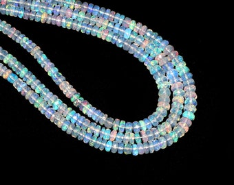 May include: A strand of iridescent opal beads, featuring a light blue and white color scheme. The beads are faceted and have a smooth, polished finish.