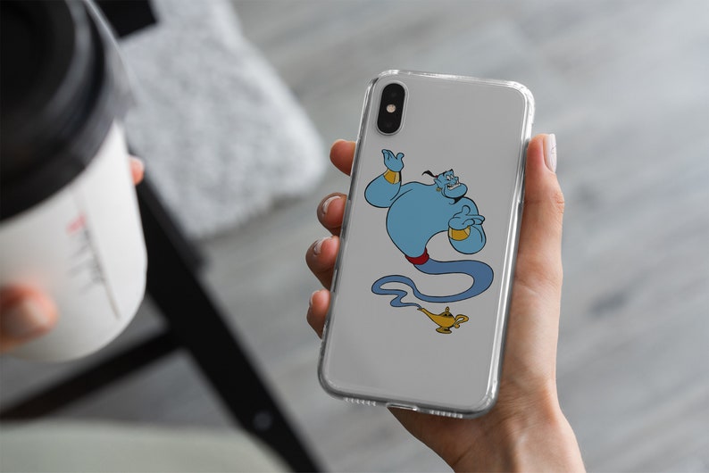 May include: A clear phone case with a cartoon image of Genie from Disney's Aladdin. Genie is blue with a red sash and is holding a lamp.