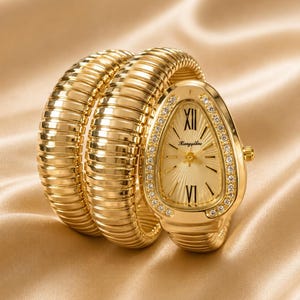 May include: A gold-toned wristwatch with a unique, coiled band. The watch face is oval-shaped, with Roman numerals and a diamond-studded bezel. The band wraps around the wrist, creating a stylish and elegant look.