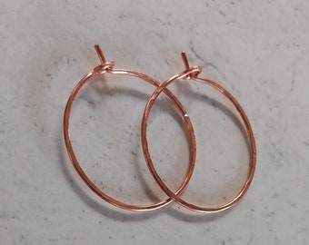 Dainty simple hammered copper hoop earrings.
