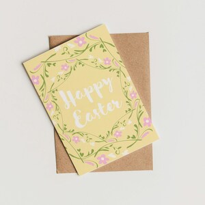 May include: A yellow card with a floral border and the text "Happy Easter" in white.