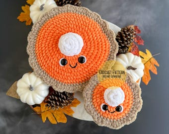 May include: Crochet pattern for a pumpkin pie amigurumi. The pattern includes instructions for making a small and a large pie. The pies have a brown crust, orange filling, and a white whipped cream topping. The pies have cute faces with black eyes and a smiling mouth.