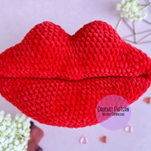 Peut inclure: Un coussin rouge en crochet en forme de lèvres. Le coussin est fait avec un fil moelleux et a une surface texturée. L'image comprend le texte "CROCHET PATTERN INSTANT DOWNLOAD".