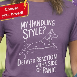 May include: Heather purple t-shirt with the text "My Handling Style? Delayed Reaction with a Side of Panic" and a graphic of a dog. The shirt also has the text "Choose your breed!"