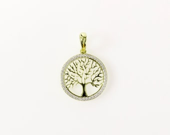 May include: A gold pendant featuring a tree of life design with clear cubic zirconia stones around the edge.