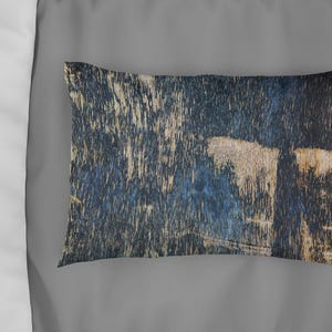 May include: A decorative throw pillow with a blue and brown abstract pattern. The pillow has a rectangular shape and a soft, textured fabric.