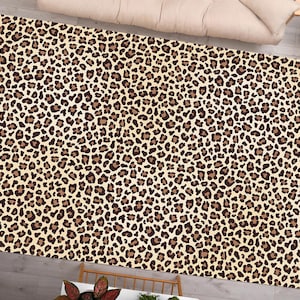 May include: A brown and beige area rug with a leopard print pattern.