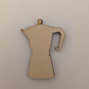 May include: A wooden cutout of a stovetop espresso maker, featuring a handle and a lid. The coffee pot is made of light-colored wood and is set against a neutral background. The design is simple and clean.