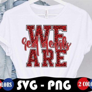May include: White t-shirt with a red and black leopard print design that says "We Red Devils Are".