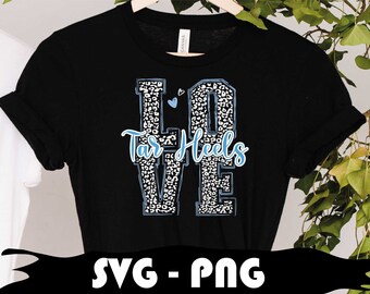 May include: Black t-shirt with a white and blue leopard print design that spells out "LOVE" with the words "Tar Heels" underneath.