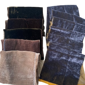 May include: A stack of six fabric swatches in various shades of brown and green, and a stack of six fabric swatches in various shades of blue.
