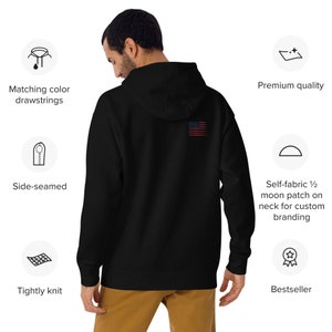 Op de afbeelding: Zwart hoodie met een klein Amerikaans vlaggetje geborduurd op de rug. De hoodie is gemaakt van strak gebreid materiaal en heeft zijnaden. Het heeft een zelfgemaakte halve maan patch op de nek voor aangepaste branding.