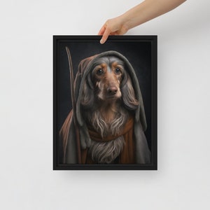 May include: A framed canvas print featuring a long-haired dachshund dressed in a hooded robe and holding a staff. The dog has brown and gray fur, with a serious expression. The robe is brown and gray, set against a dark background.