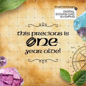 May include: A digital download graphic with the text "this precious is one year old!" on a parchment-style background. The design includes decorative swirls, a compass rose, and gemstone accents. The words "DIGITAL DOWNLOAD SVG+PNG" are also present.