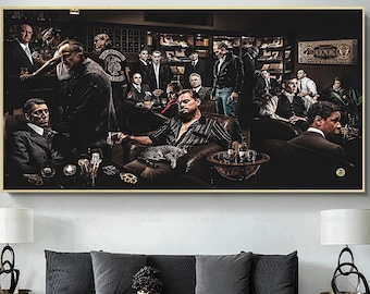 May include: A framed wall art print depicting a group of men in a dimly lit room, some seated and others standing. The artwork features a dark color palette with a gold frame, and a cat is resting on a man's lap.