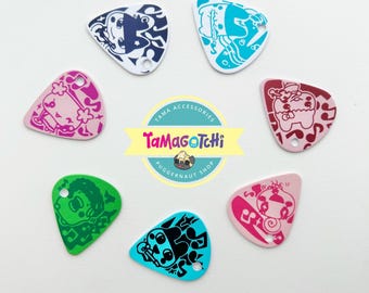 Réplica de amuleto de púa de guitarra Tamagotchi