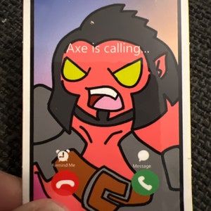 May include: A sticker depicting a cartoon smartphone screen with a red-skinned character with black hair and yellow eyes. The text "Axe is calling..." appears on the screen. Icons for "Remind Me" and "Message" are also visible.