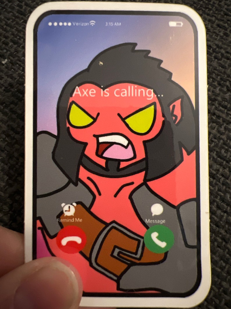May include: A sticker depicting a cartoon smartphone screen with a red-skinned character with black hair and yellow eyes. The text "Axe is calling..." appears on the screen. Icons for "Remind Me" and "Message" are also visible.
