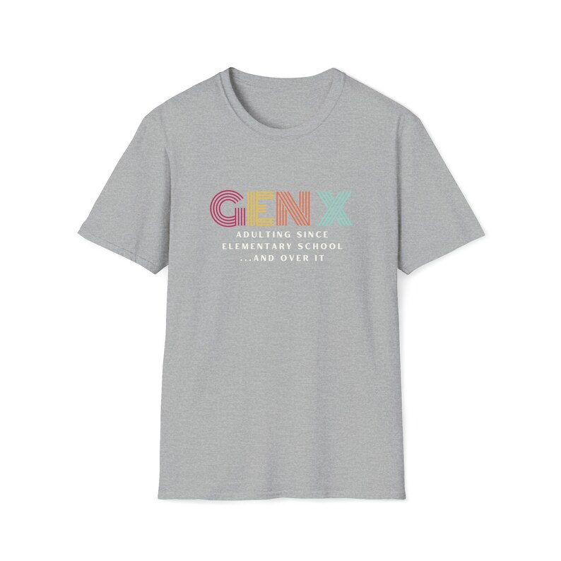 Gildan softstyle tee in Sport Grey that says Gen X in colorful large letters over smaller white letters that say Adulting Since Elementary School...and Over It