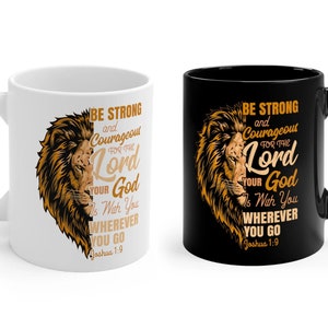 May include: Two coffee mugs with a black and white design. The design features a lion with the text "Be strong and courageous for the Lord your God is with you wherever you go Joshua 1:9".