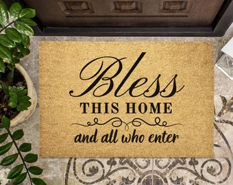 May include: A brown coir doormat with the text "Bless this home and all who enter" in black cursive lettering.