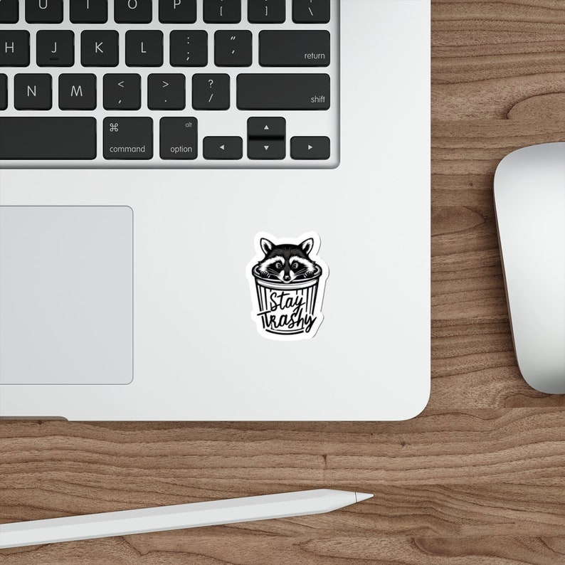 Water resistant feral raccoon trash panda funny die cut sticker with Stay Trashy slogan, perfect for laptops, tumblers, water bottles, journals, and more! Raccoon gifts for animal lovers in their feral era.
