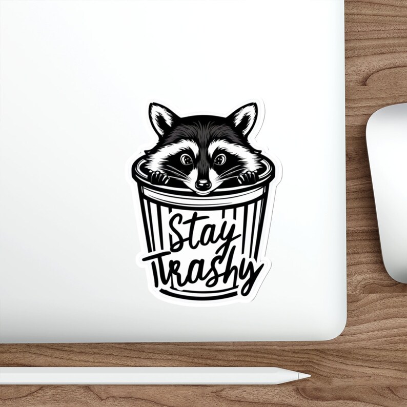 Water resistant feral raccoon trash panda funny die cut sticker with Stay Trashy slogan, perfect for laptops, tumblers, water bottles, journals, and more! Raccoon gifts for animal lovers in their feral era.