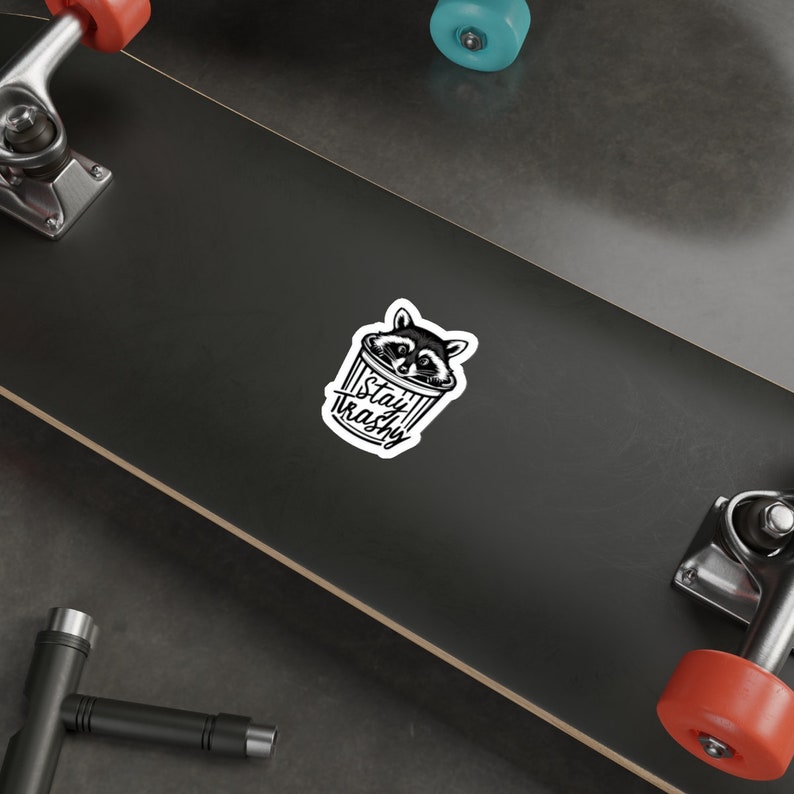 Water resistant feral raccoon trash panda funny die cut sticker with Stay Trashy slogan, perfect for laptops, tumblers, water bottles, journals, and more! Raccoon gifts for animal lovers in their feral era.
