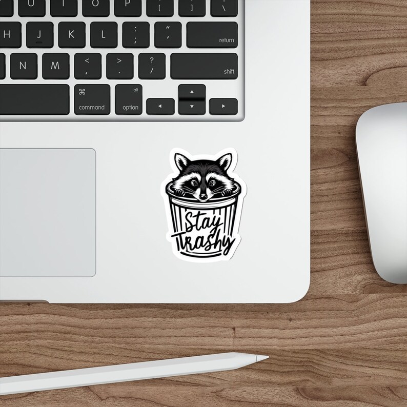 Water resistant feral raccoon trash panda funny die cut sticker with Stay Trashy slogan, perfect for laptops, tumblers, water bottles, journals, and more! Raccoon gifts for animal lovers in their feral era.