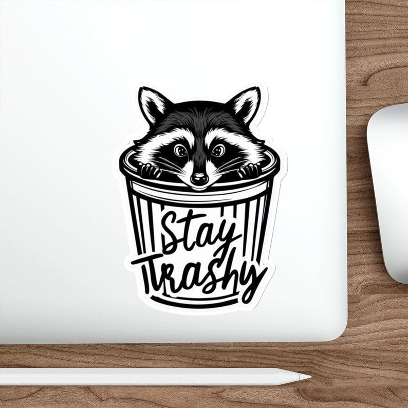 Water resistant feral raccoon trash panda funny die cut sticker with Stay Trashy slogan, perfect for laptops, tumblers, water bottles, journals, and more! Raccoon gifts for animal lovers in their feral era.