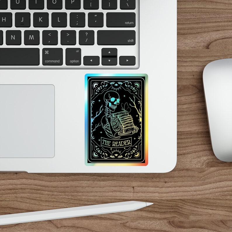 Holographic tarot card sticker featuring a skeleton holding a stack of books with a butterfly atop, surrounded by celestial stars and tree branches. Perfect for laptops, journals, water bottles, and scrapbooks. Ideal gift for readers and book lovers.