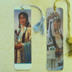 May include: Two bookmarks featuring Native American imagery. The bookmark on the left features a woman in traditional clothing with a blue and white beaded necklace. The bookmark on the right features a man in a headdress with a beaded vest and a feather headdress.