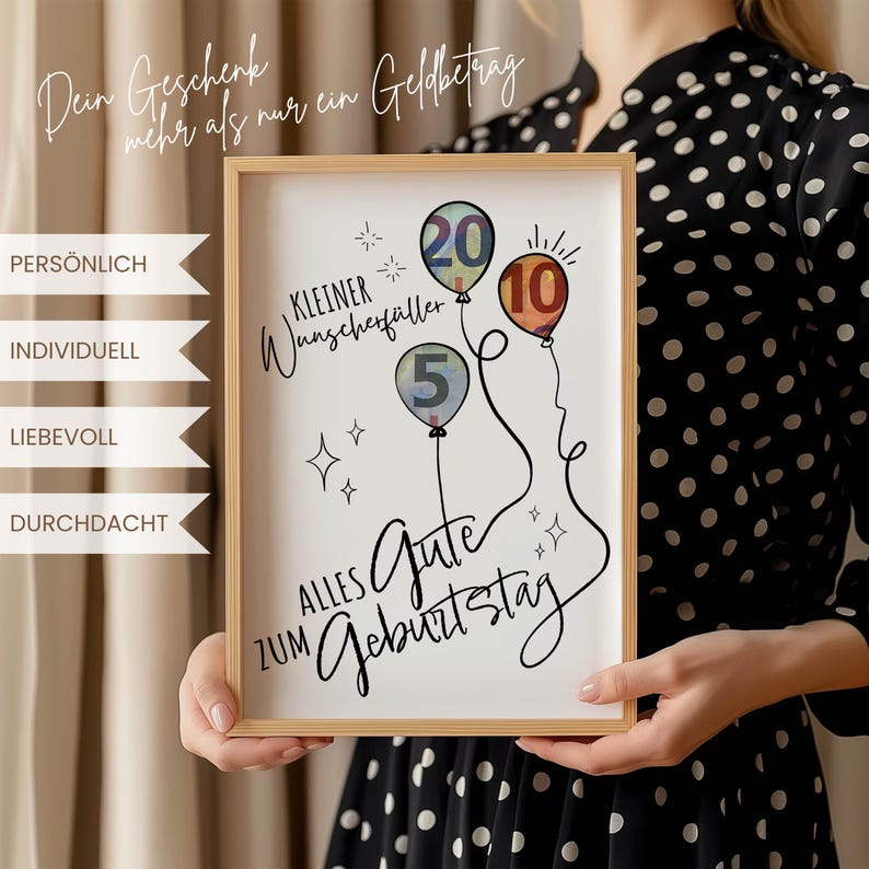 May include: A framed print with a light wood frame. The print features three balloons with the numbers 5, 10, and 20, and the words "Alles Gute zum Geburtstag." The print also includes the text "Dein Geschenk mehr als nur ein Geldbetrag."