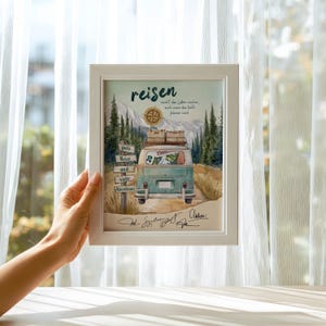 May include: A white framed print featuring a watercolour illustration of a teal van driving on a dirt road through a forest. The text reads reisen, gute Reise und viele Abenteuer, and includes a compass graphic, luggage on the roof, and signatures.