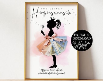 May include: A framed print featuring a black silhouette of a girl with a crown holding a dandelion. A pink watercolor splash serves as a background for a skirt made of folded Euro banknotes and a pink ribbon. Text reads: FÜR DEINEN Herzenswunsch.