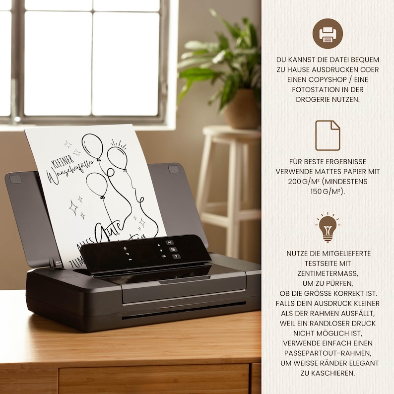 May include: A black inkjet printer with a printed card featuring balloon illustrations and the text "Kleiner Wunschzettel" and "Alles Gute". The printer is on a wooden surface, with a window and a stool in the background.