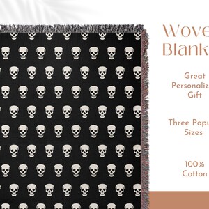 May include: Black and white woven throw blanket with a skull pattern. The blanket has fringe on all sides. The text "Woven Blanket" is written in brown text above the blanket. The text "Great Personalized Gift" is written in brown text below the blanket. The text "Three Popular Sizes" is written in brown text below the blanket. The text "100% Cotton" is written in brown text below the blanket.