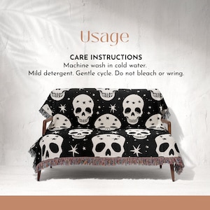May include: Black and white throw blanket with a skull and star pattern. The blanket is draped over a couch. Care instructions: Machine wash in cold water. Mild detergent. Gentle cycle. Do not bleach or wring.