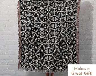 May include: Black and white woven throw blanket with a geometric pattern of overlapping circles and lines. The blanket has a fringe border. "Makes a Great Gift!" is written in white text on a black background in the lower right corner of the image.
