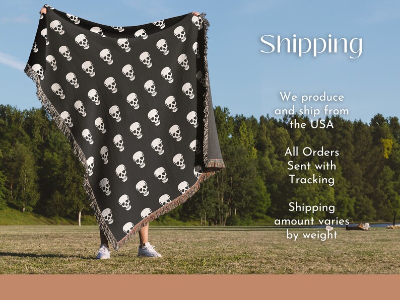 May include: A person holding up a black woven throw blanket with a white skull pattern. The blanket has fringe on the edges. The person is standing in a grassy field with trees in the background. The text "Shipping" is written in white letters on a black background above the person's head. The text below the person says "We produce and ship from the USA. All Orders Sent with Tracking. Shipping amount varies by weight."