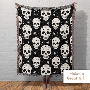 May include: Black and white woven throw blanket with a skull and star pattern. The blanket has a fringed edge. Makes a Great Gift!