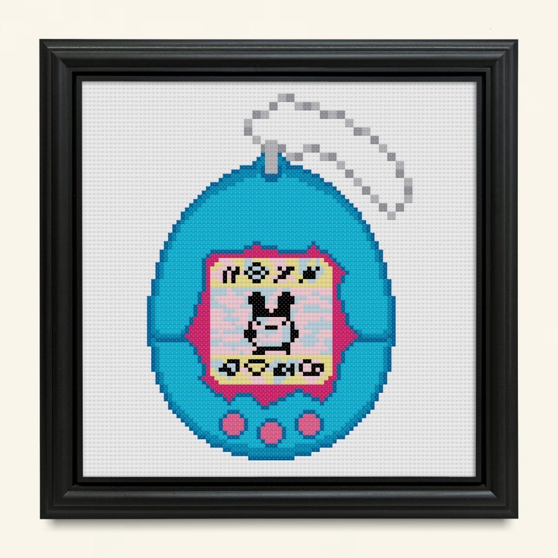 May include: A blue and pink pixelated image of a Tamagotchi, a virtual pet toy. The screen displays a cartoon character with the text "NOXY" and "AOVO"