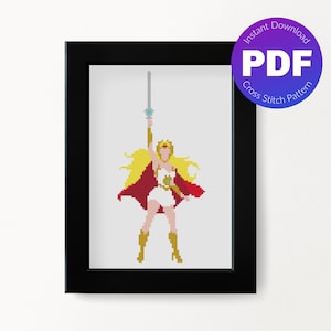 May include: A cross stitch pattern of a female character with long blonde hair, wearing a white dress, red cape, and gold boots, holding a sword in her right hand. The pattern is framed in black.